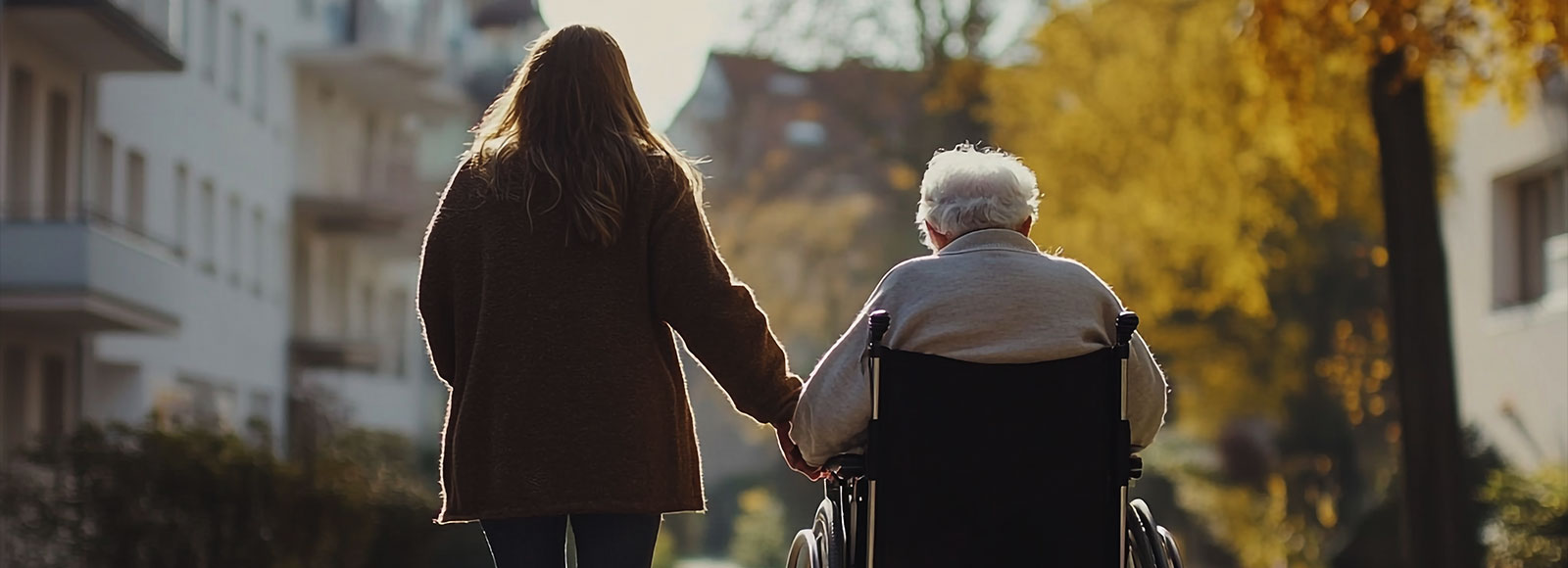 Caretaker with elderly relative in a wheelchair